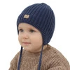 Czapka zimowa dla chłopca, granatowa, wiązana, 100% wełniana merino, podszyta polarem merino, Buno